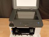 the printer is sitting on top of the printer tray on the table