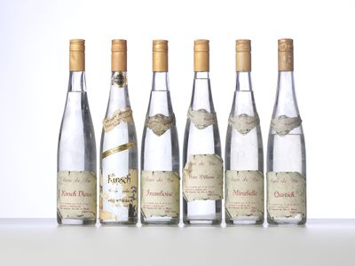 six bottles of wine are lined up in a row on a table