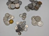 a lot of silver and gold coins on the table