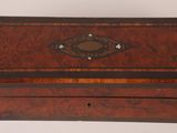 an old wooden box with a decorative design on the lid