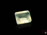 an image of a green quartz stone on a black surface
