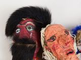 two puppets of people with different faces on them