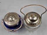 pair of antique silverplated teapots with blue glass lids