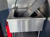 a sink with a fire extinguisher next to it