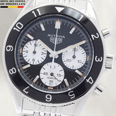 a close up of a watch with a black face