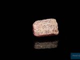 a close up of a piece of rock on a black surface