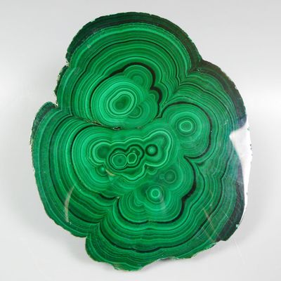 a picture of a piece of green agate on a white surface