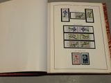 an open book with stamps on it sitting on a table
