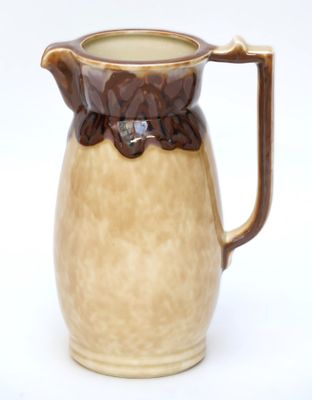 une cruche marron et blanche sur fond blanc