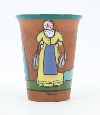 a ceramic cup with a picture of a woman in a yellow dress