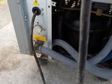a close up of a machine with a hose attached to it