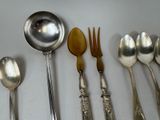 several spoons, forks, and spoons are lined up on a table