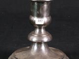 two silver candlesticks on a black background