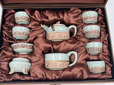 a box with a set of tea cups and saucers in it