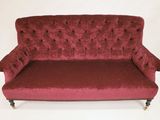 an image of a red couch sitting on top of a white floor