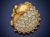 a close up of a gold and diamond hedge broochle