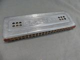 a silver harmonica sitting on top of a table