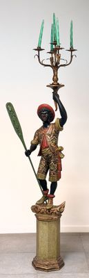 a statue of a man holding a paddle and a candelab