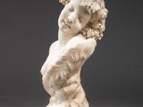 a white marble bust of a woman with curly hair