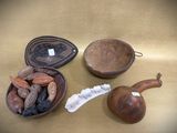a bowl of nuts and a bowl of chocolate beans on a table