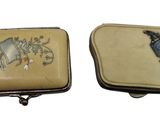 pair of small leather purses with blue and white designs on them