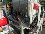 a pile of assorted items and tools in a garage