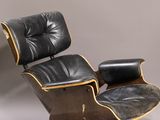 an image of a black leather chair and ottoman in a room