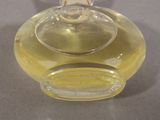 a small glass bottle with a lid on a table