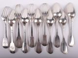 a lot of silver spoons and forks on the table