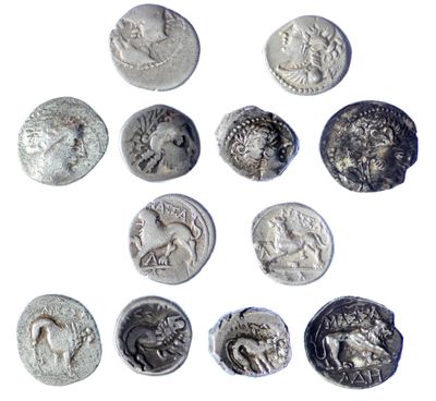 six ancient roman coins are arranged in a circle on a white surface