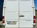 the back of a white van is parked in the grass