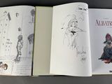 an open book with a drawing of a woman and a man on it