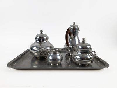 a silver tray with a silver tea set on it