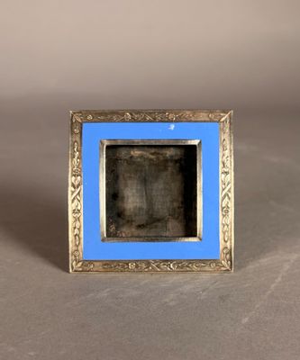 an old picture frame with a blue border on a gray surface