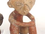 two figurines sitting next to each other on a table
