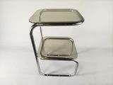 a small metal table with a tray on top of it