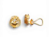 pair of gold tone clip earrings with a design of a man and a woman on a boat