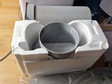 a box with a bowl inside of it on a table