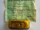 an old gold bar sitting on top of a piece of paper