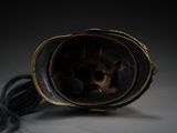 a helmet with a long black hair on a table