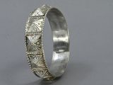 a close up of a silver ring on a gray surface