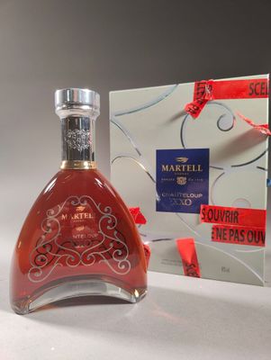 a bottle of wine that is sitting next to a box