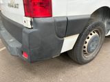the rear end of a white truck with a red tail light