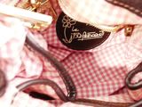 a close up of a purse that has a tag on it