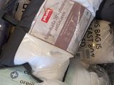 a pile of bedding and pillows on the floor
