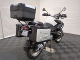 a motorcycle that is parked in a room with a black and white checkered floor