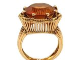 an image of a gold ring with a large brown stone