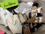 many pairs of shoes in a bag with a name tag on it
