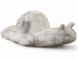 a white marble snail sitting on a white surface