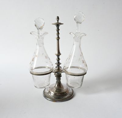 three glass vases on a metal stand with a candle holder